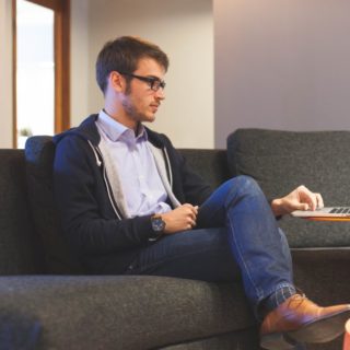 Man using his laptop on a couch